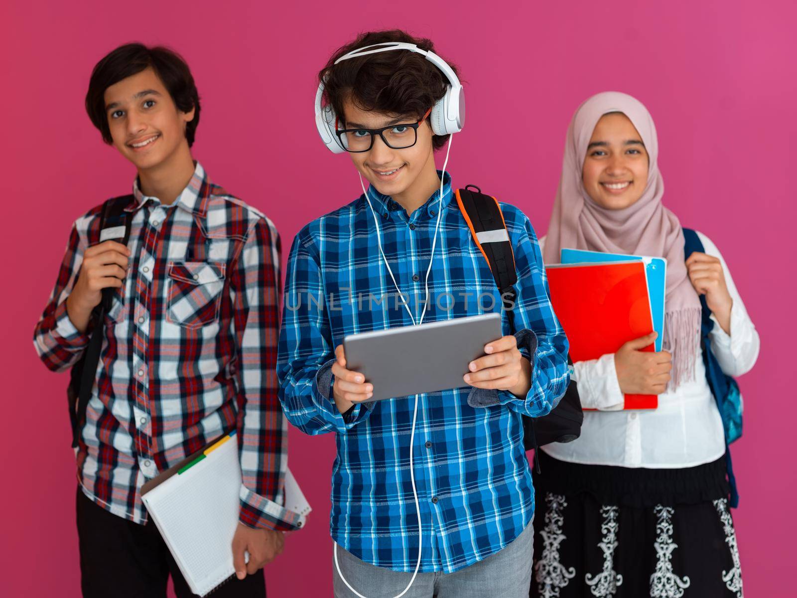 Modern Arab teens use smartphones, tablets, and laptops to study during online classes due to corona virus pandemic. High quality photo