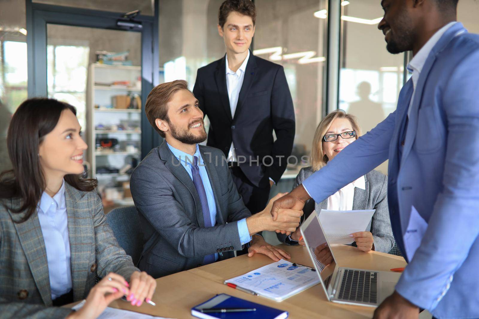 Business people shaking hands on a company meeting. by tsyhun