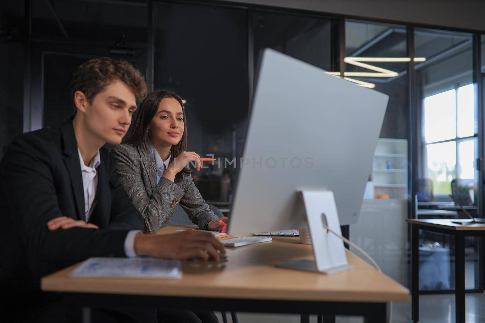 Two business people working together on computer