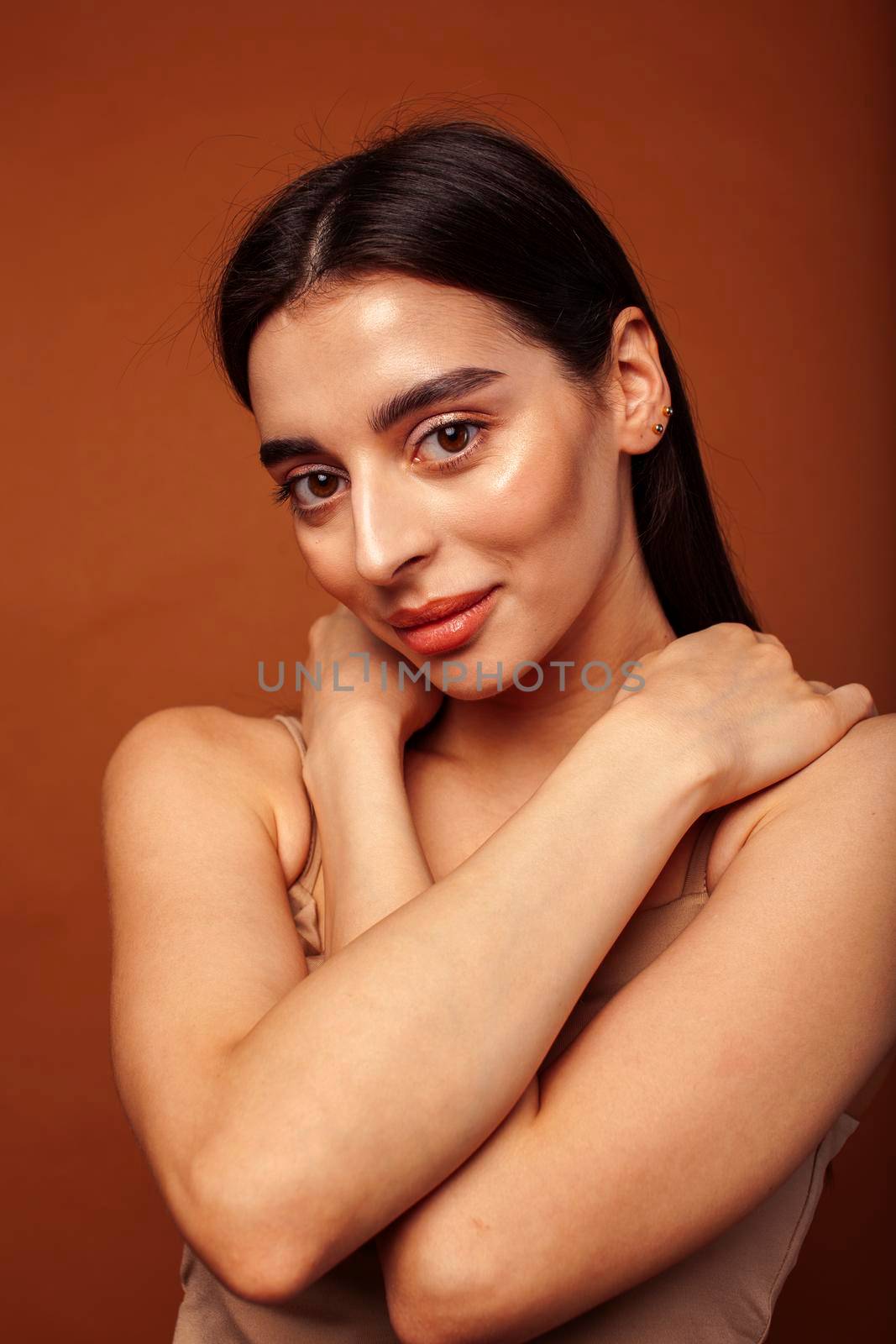 cute happy young indian woman in studio closeup smiling on brown background, fashion beauty lifestyle people concept close up