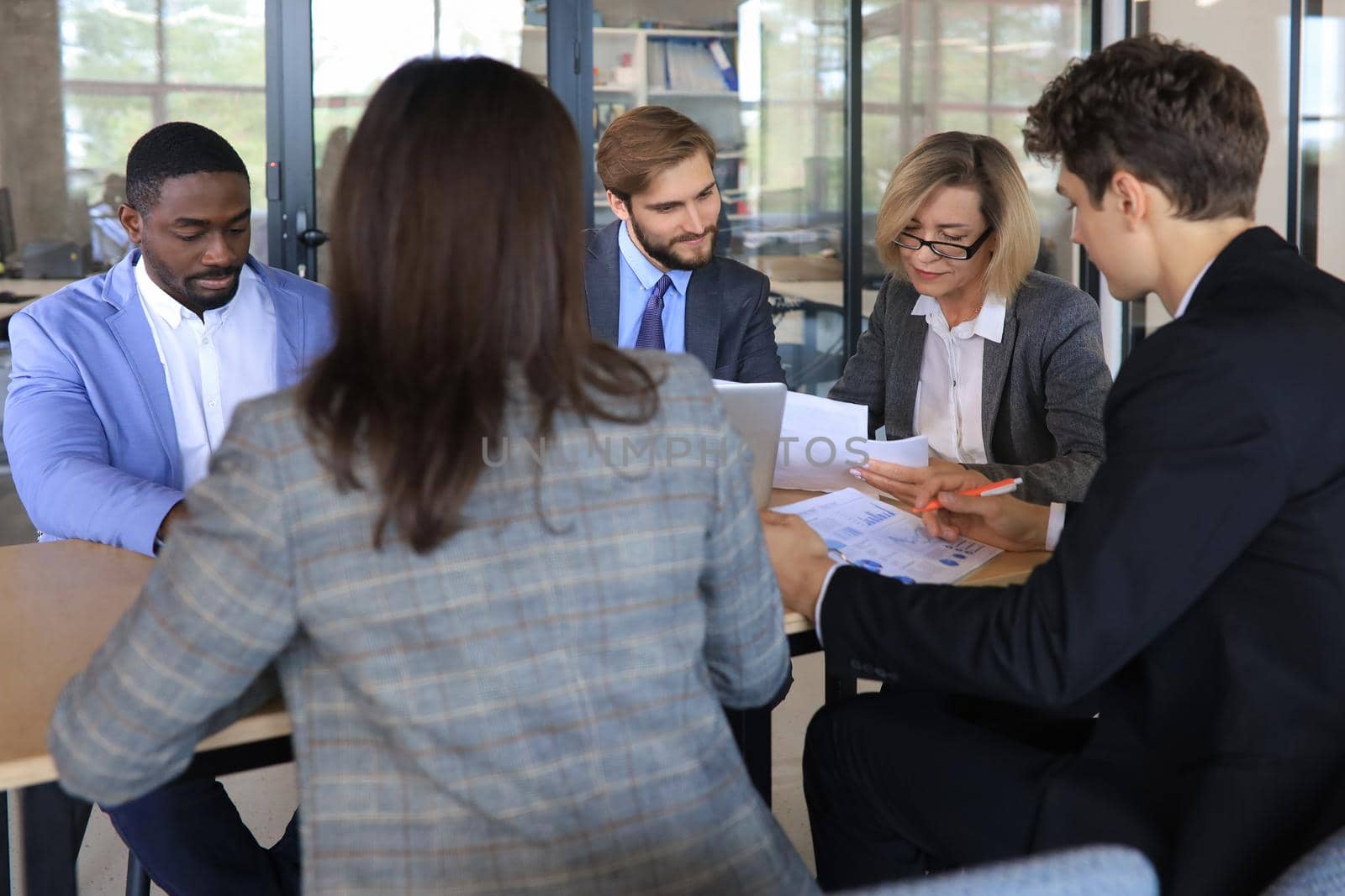 Group of happy young business people in a meeting at office