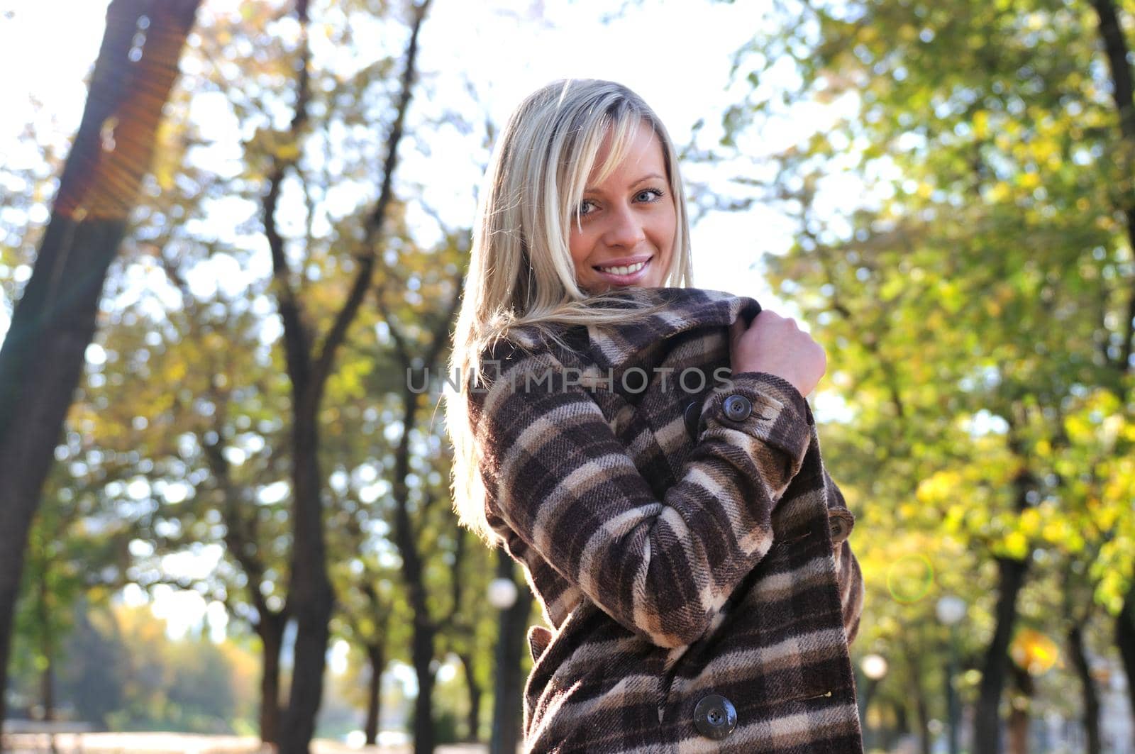 blonde Cute young woman smiling outdoors by dotshock