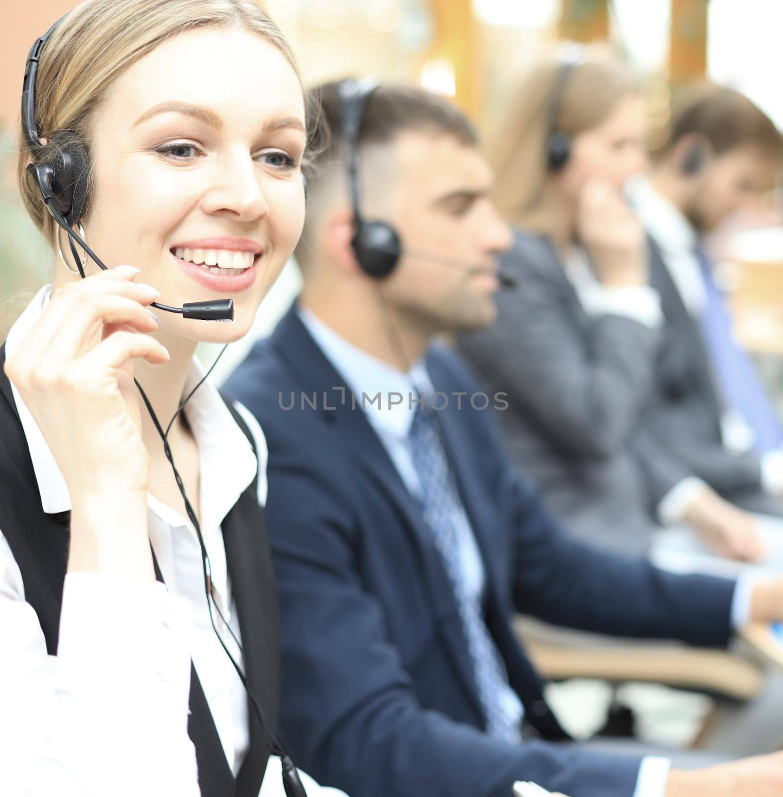 Female customer support operator with headset and smiling. by tsyhun