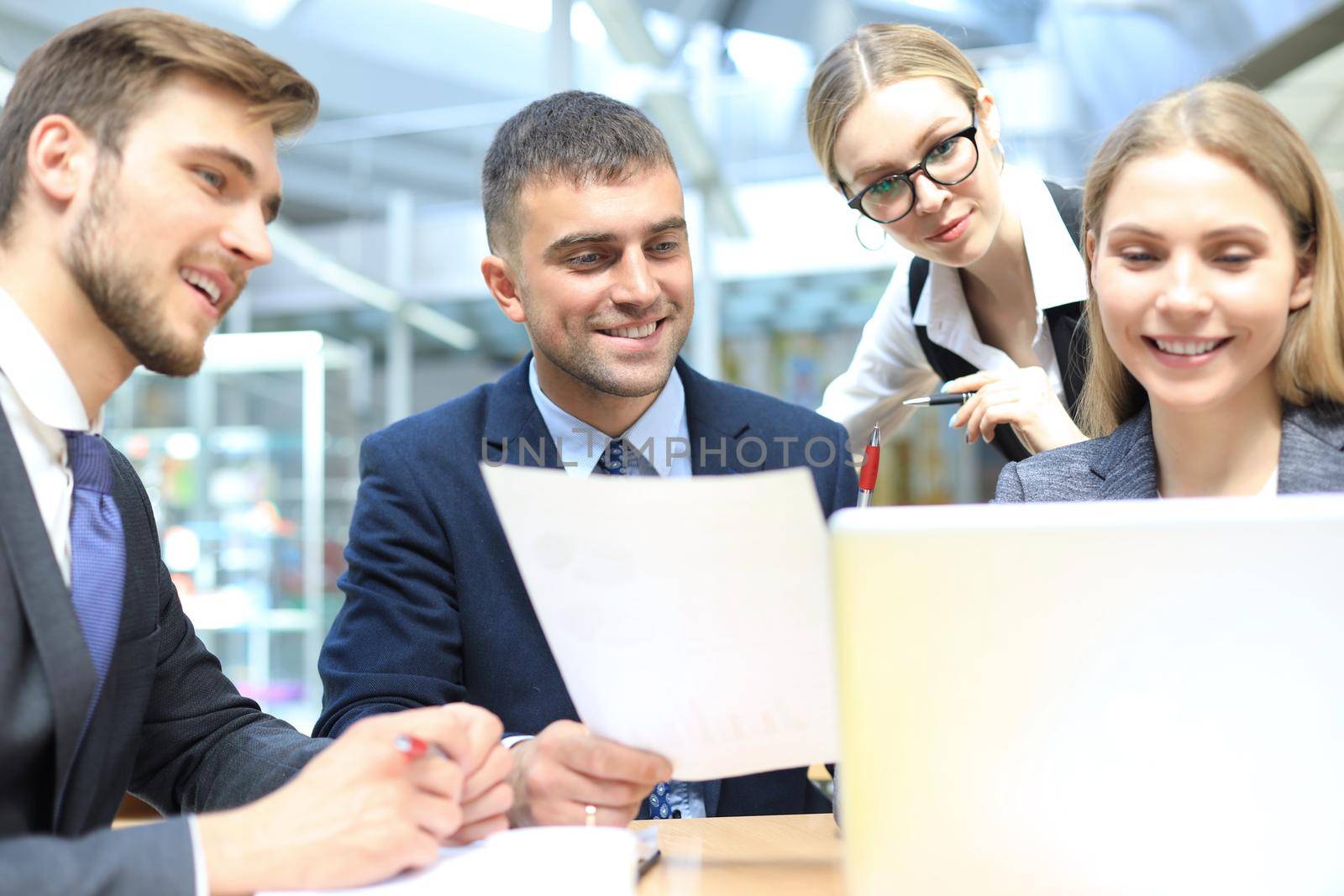 Image of business partners discussing documents and ideas at meeting. by tsyhun