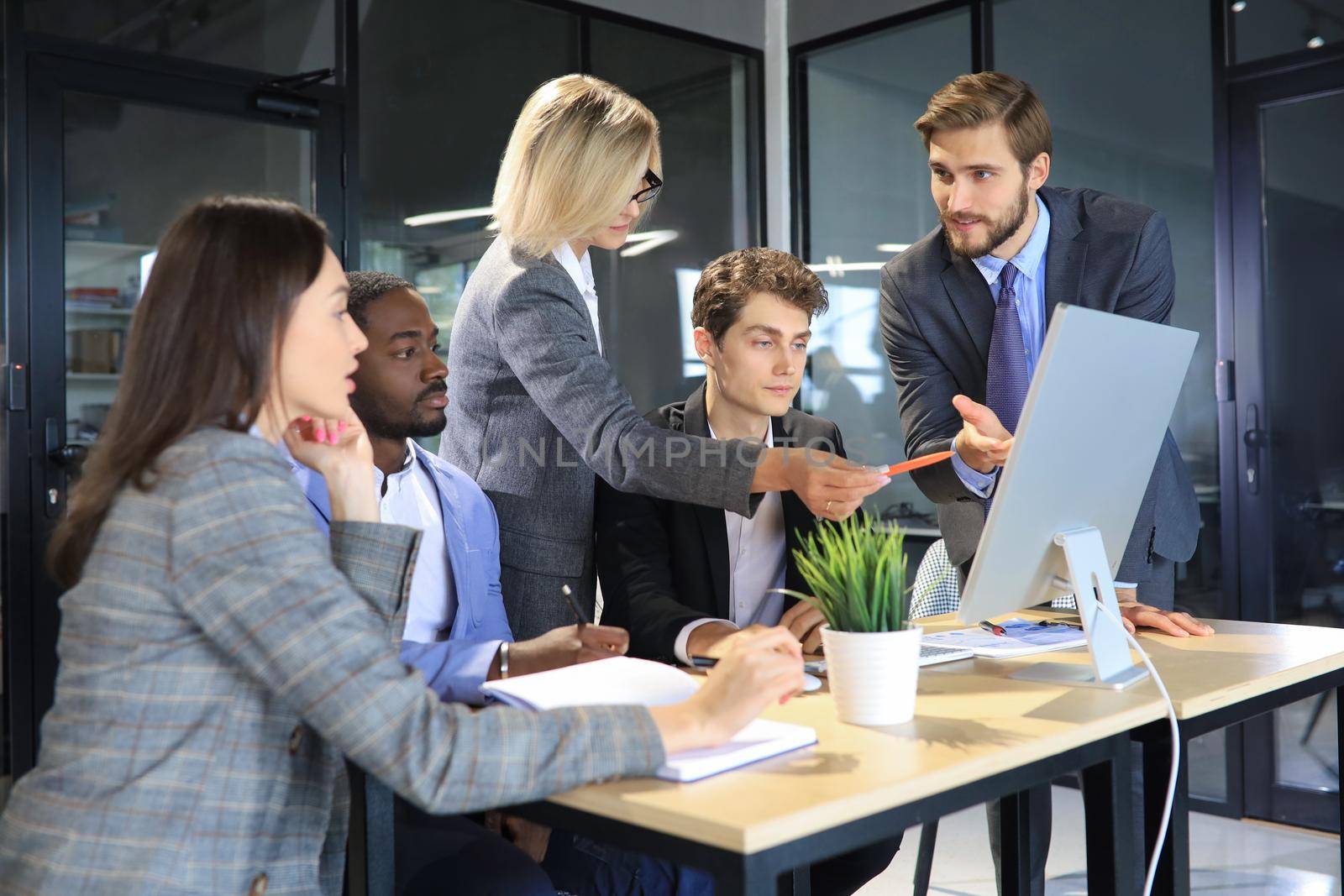 Group of business people in a meeting discussing and planning a project. by tsyhun