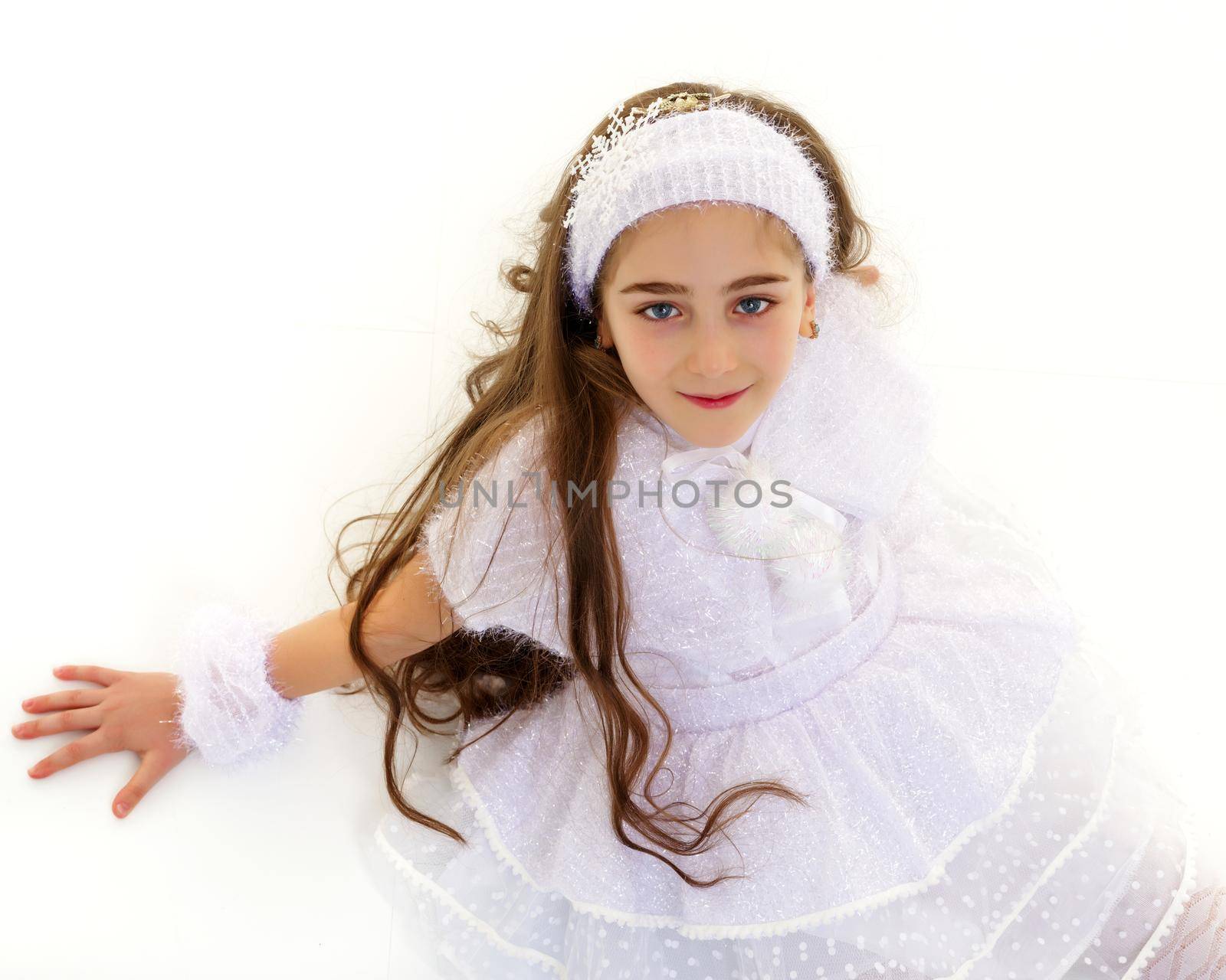 Portrait of a beautiful little girl looking from above. The concept of happy people, childhood. Isolated on white background. Close-up.