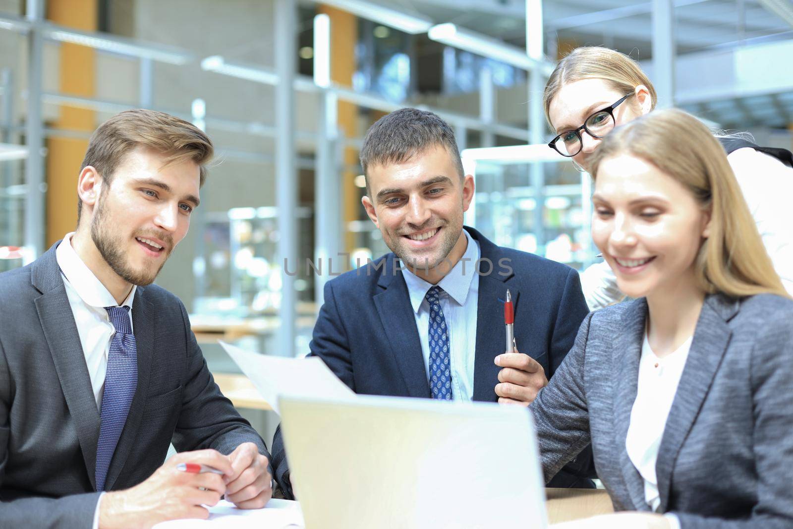 Image of business partners discussing documents and ideas at meeting