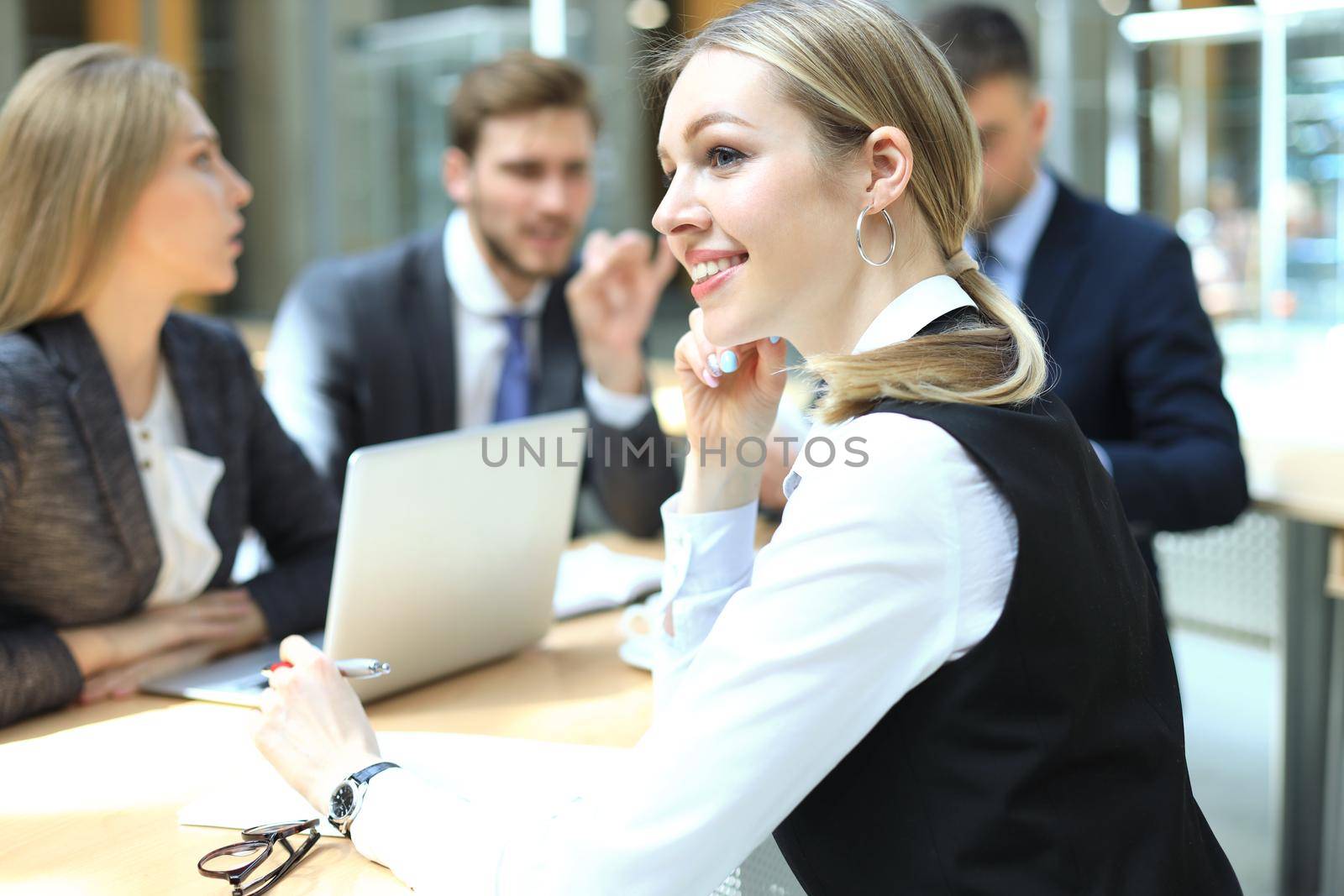 Face of beautiful woman on the background of business people