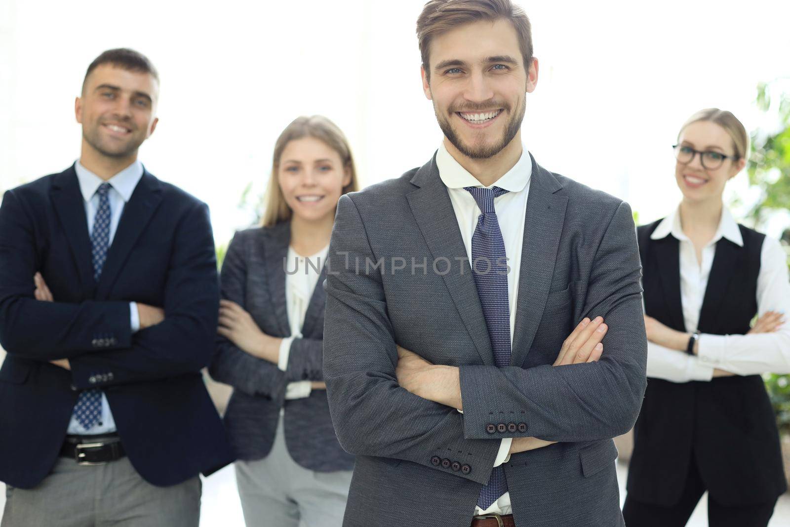 Businessman with colleagues in the background in office