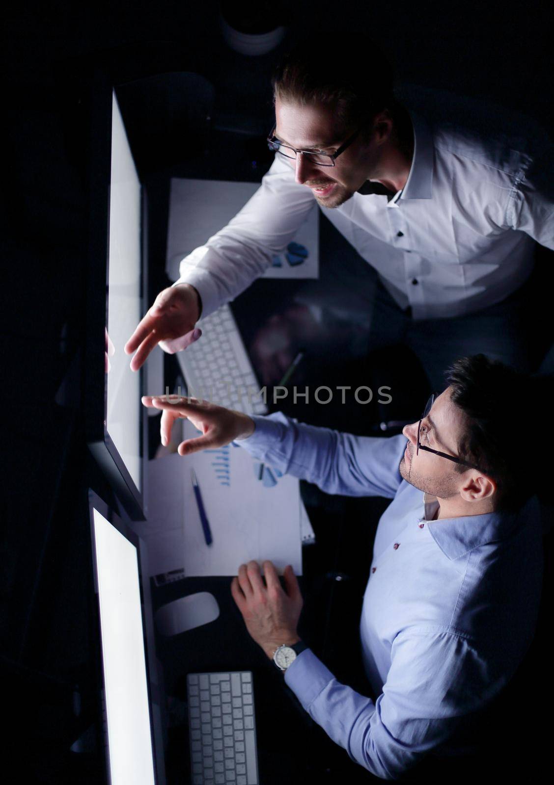 top view .business colleagues discussing information on the computer screen by asdf