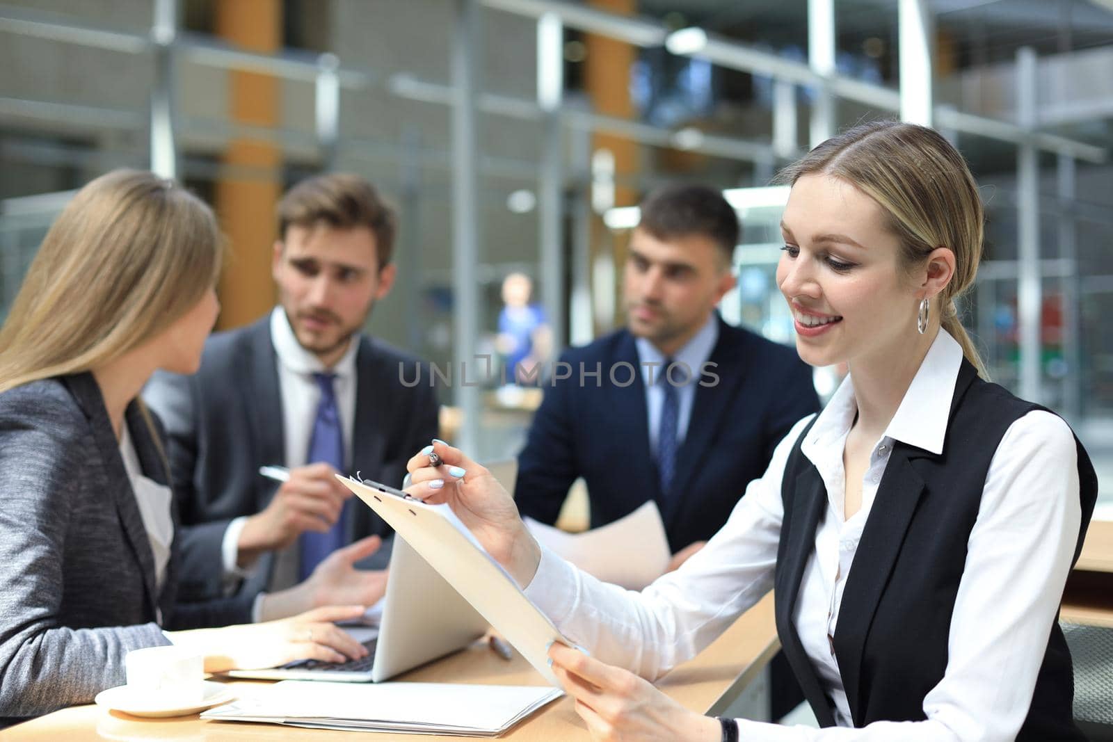 business woman with her staff, people group in background at modern bright office indoors