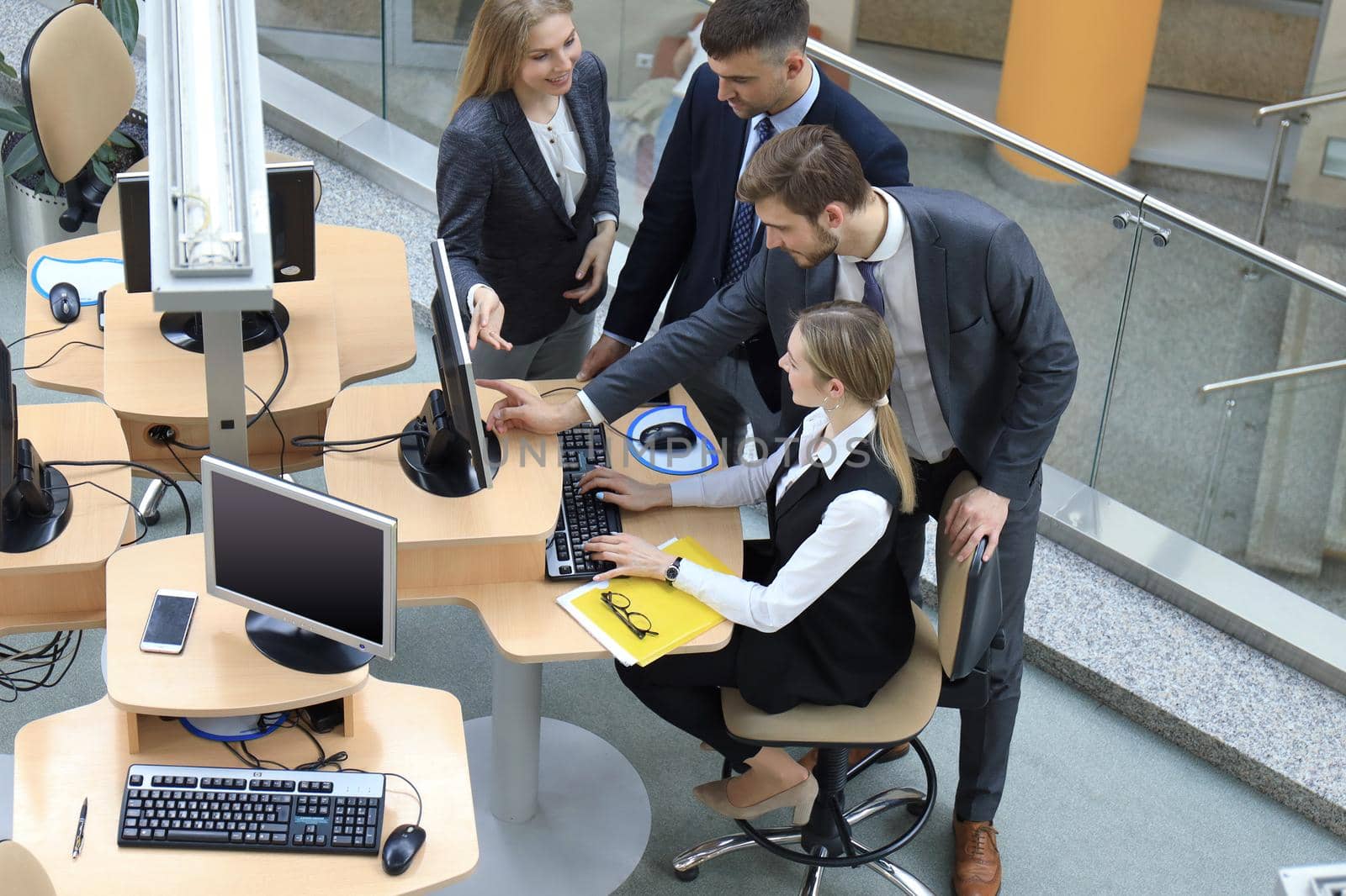 Top view of buiness team brainstorming while sitting at the office table together