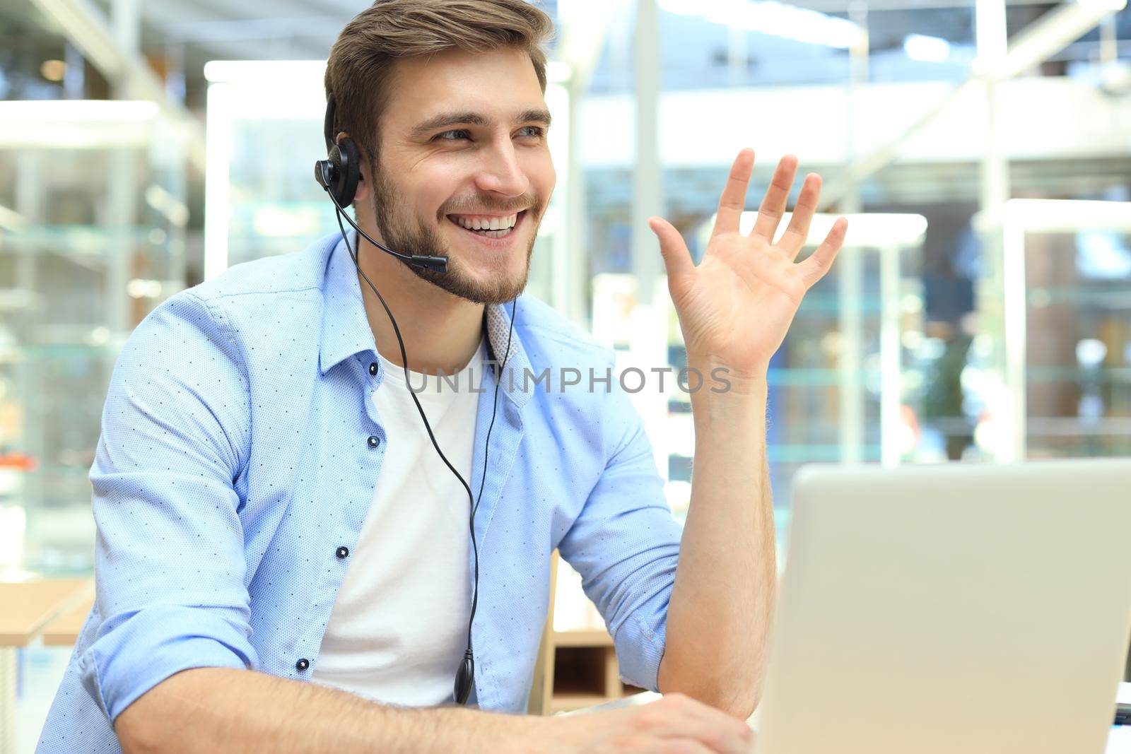 Happy young male customer support executive working in office