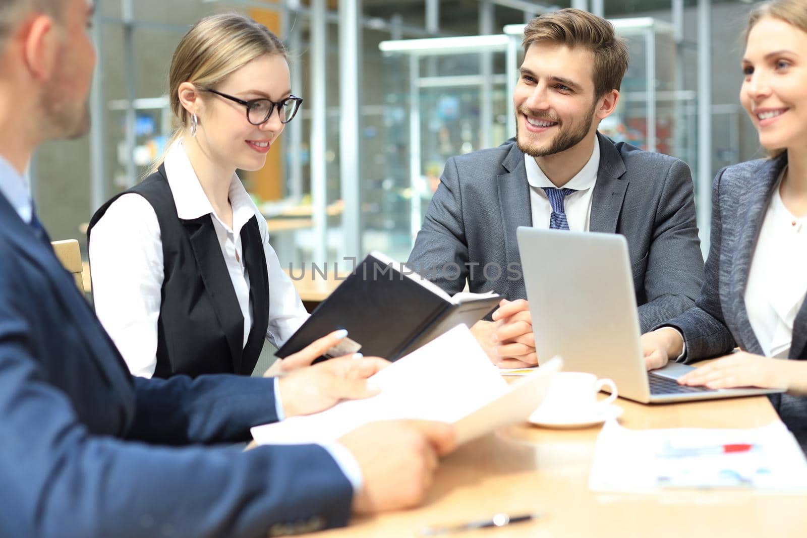 Group of business partners discussing ideas and planning work in office