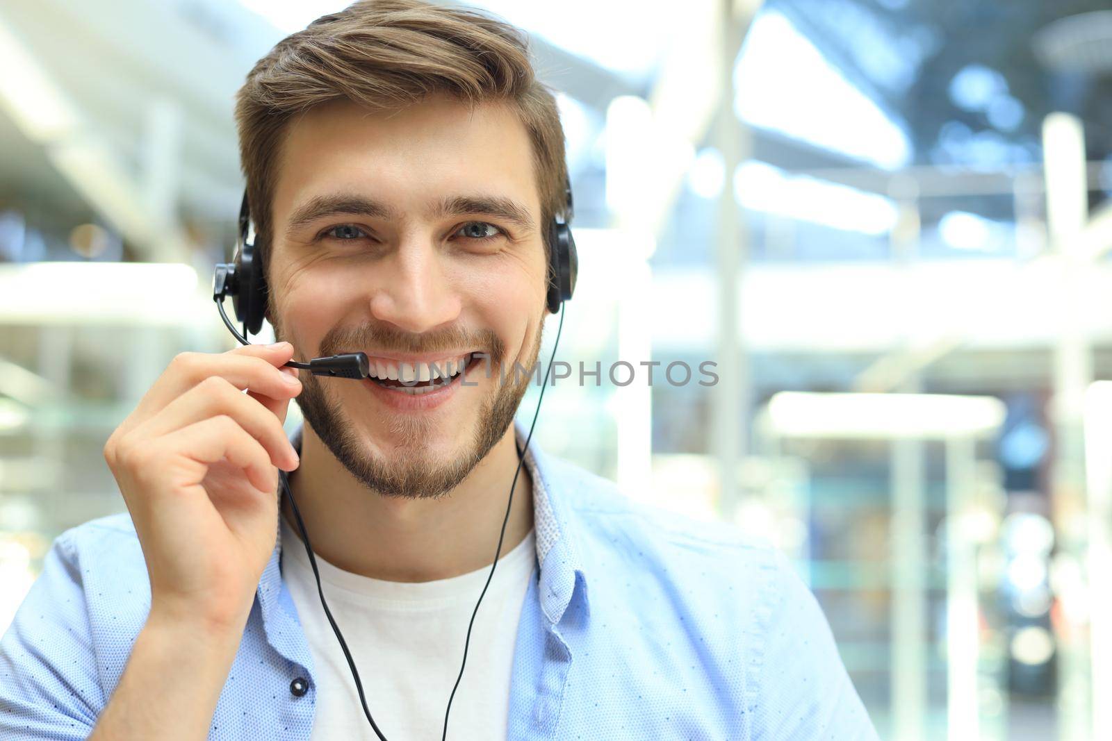 Happy young male customer support executive working in office