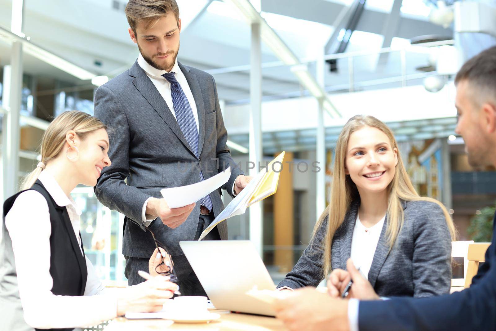 Image of business partners discussing documents and ideas at meeting