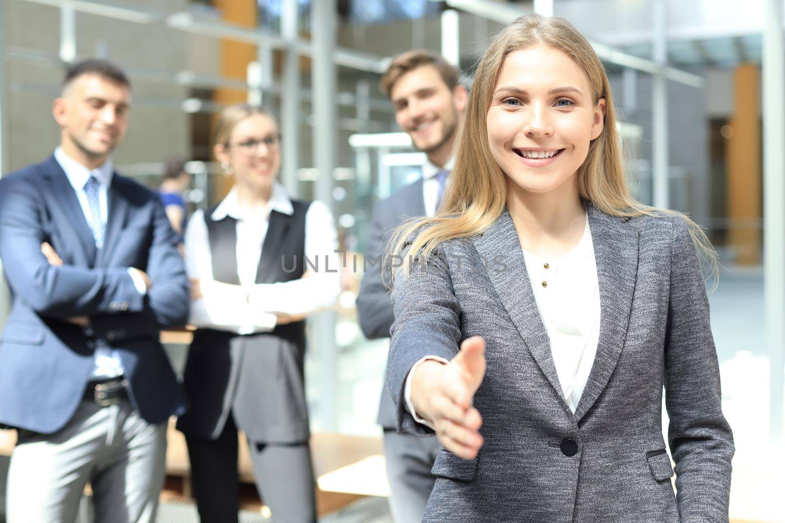 woman with an open hand ready for handshake in office