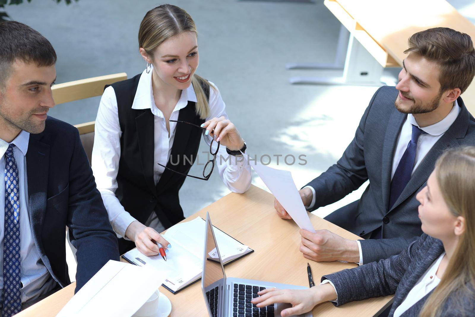 Image of business partners discussing documents and ideas at meeting