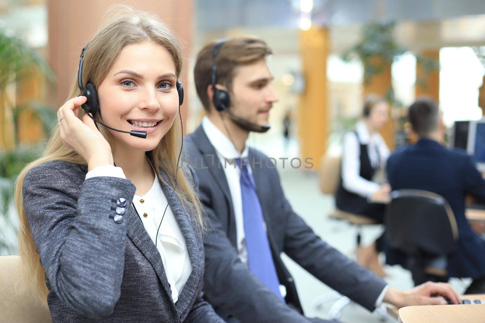 Female customer support operator with headset and smiling