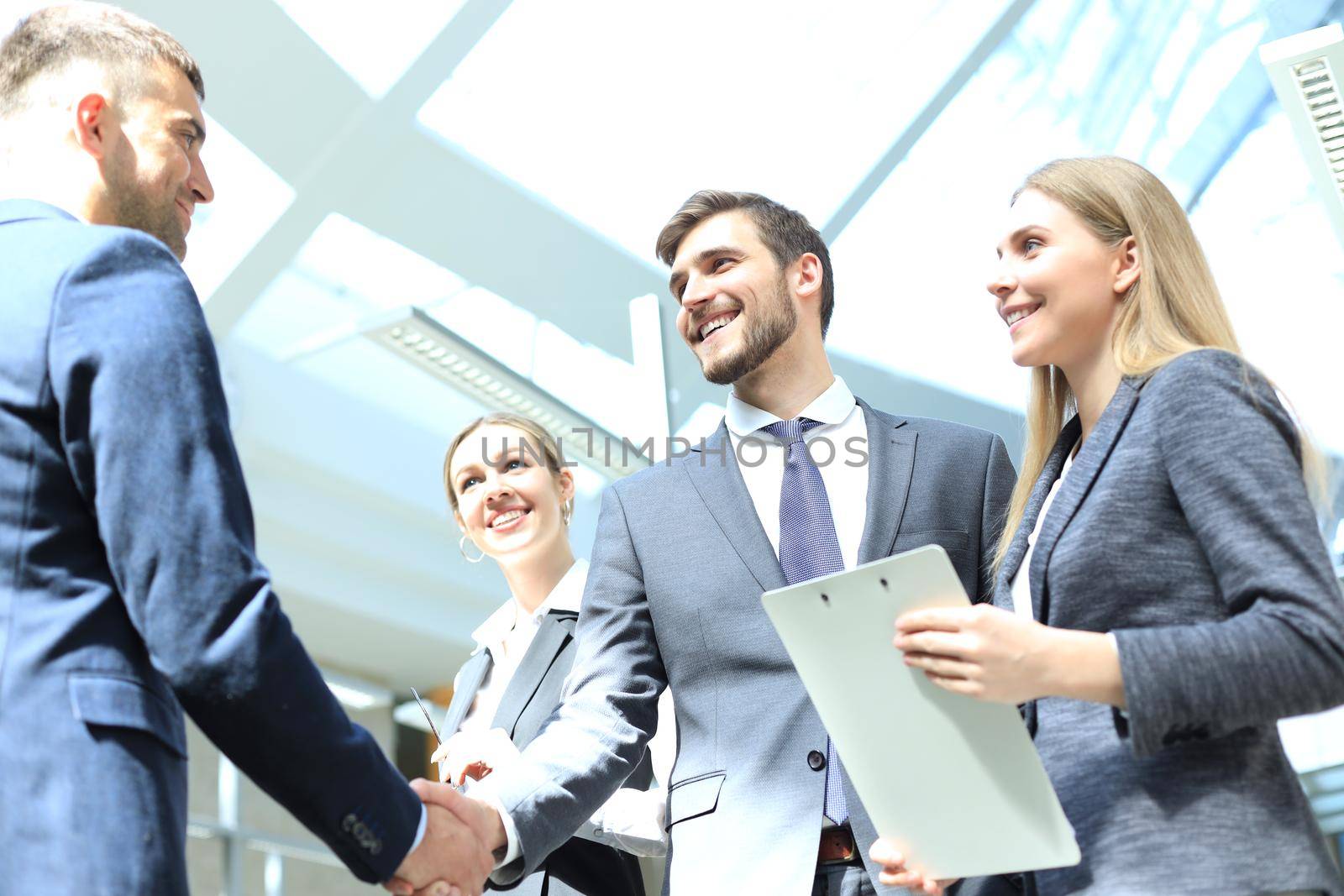 Business people shaking hands, finishing up a meeting. by tsyhun