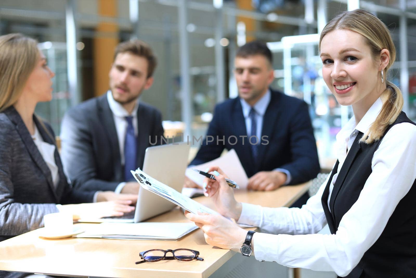 business woman with her staff, people group in background at modern bright office indoors. by tsyhun