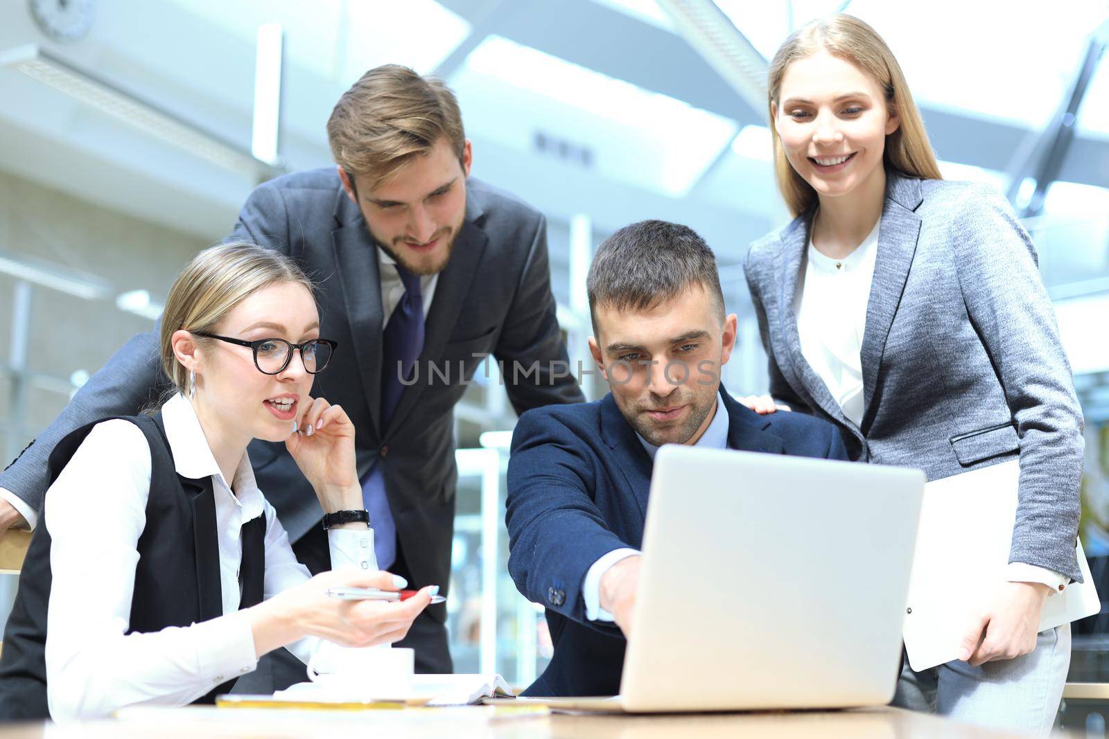 Image of business partners discussing documents and ideas at meeting. by tsyhun