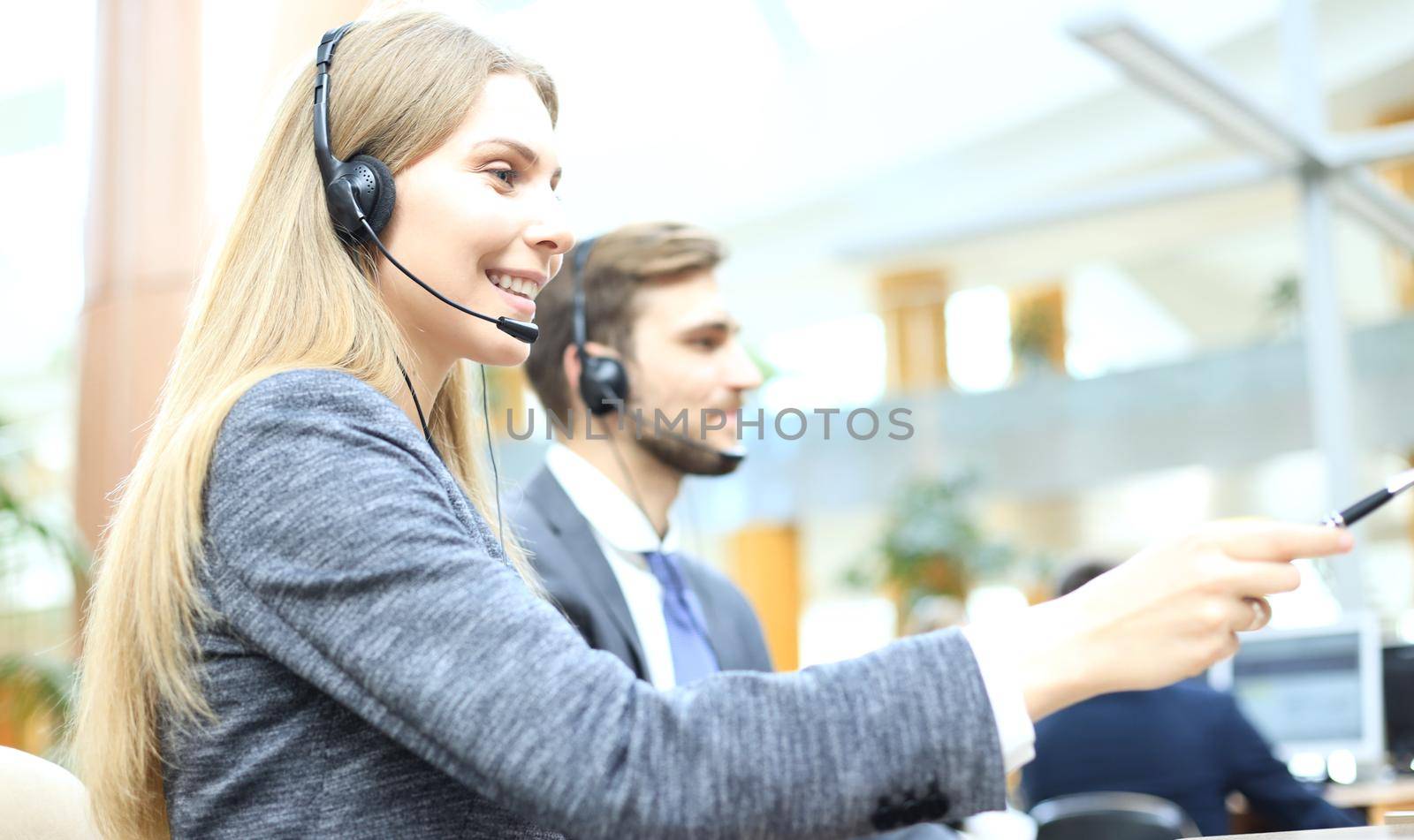 Female customer support operator with headset and smiling