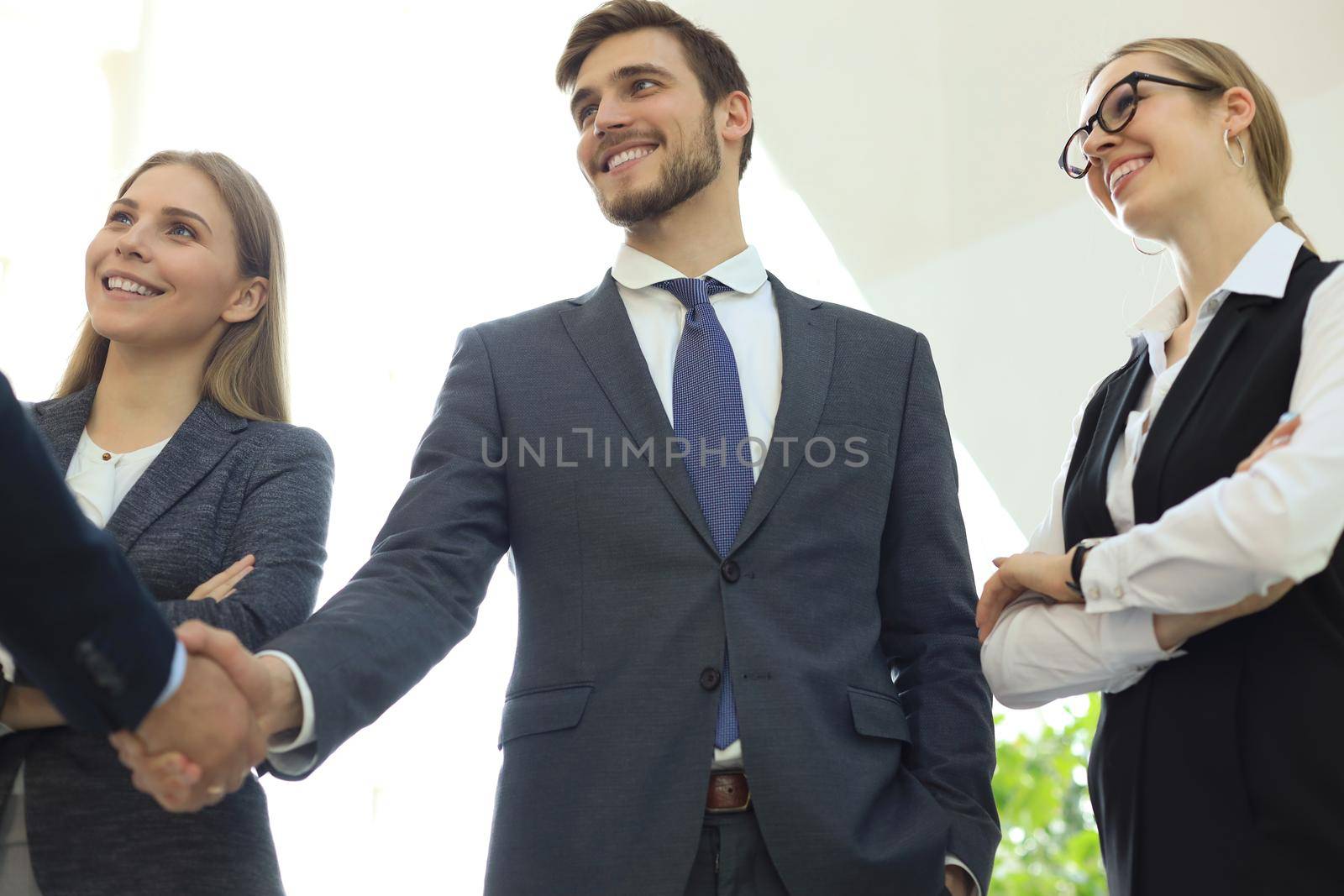 Business people shaking hands, finishing up a meeting. by tsyhun