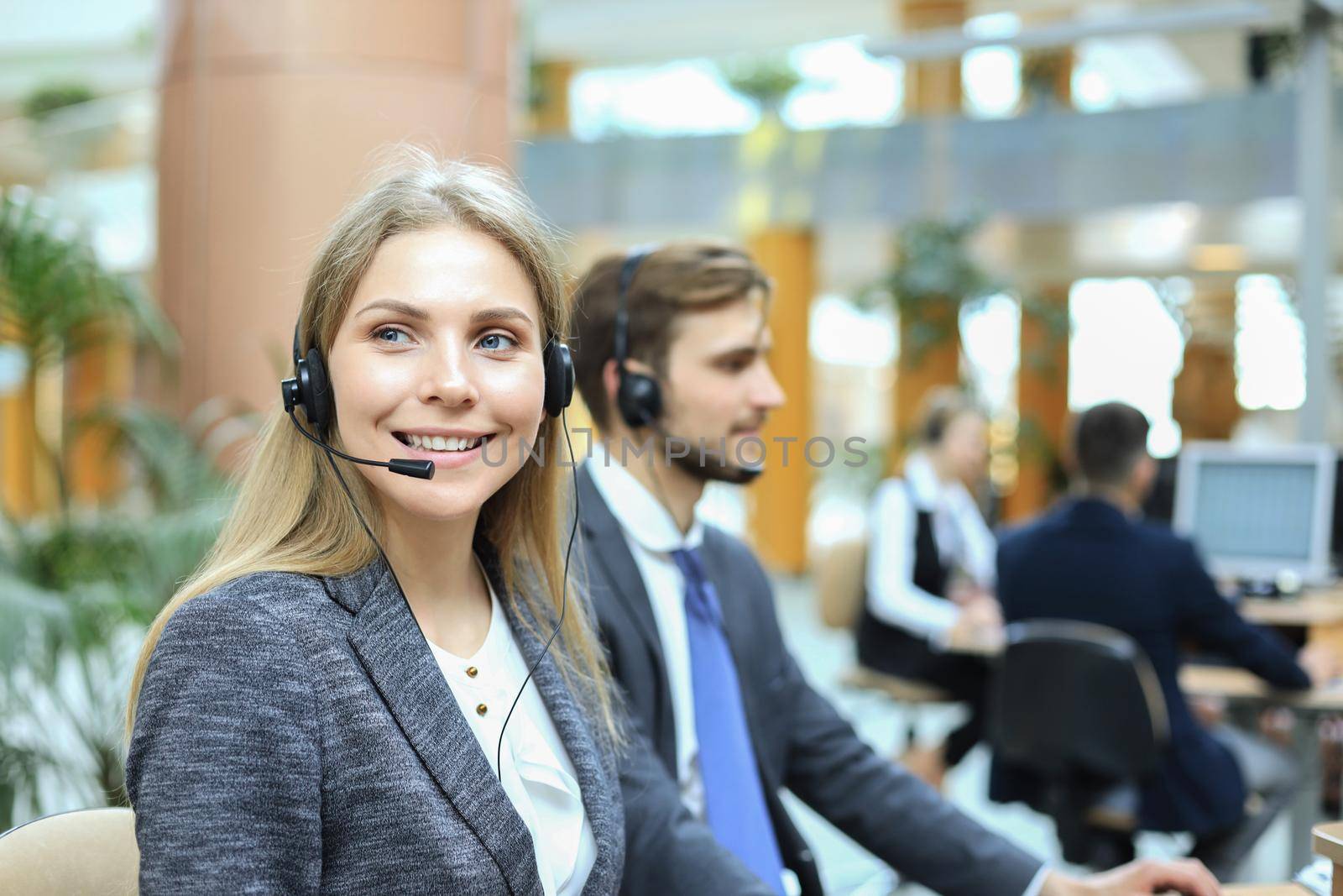 Female customer support operator with headset and smiling