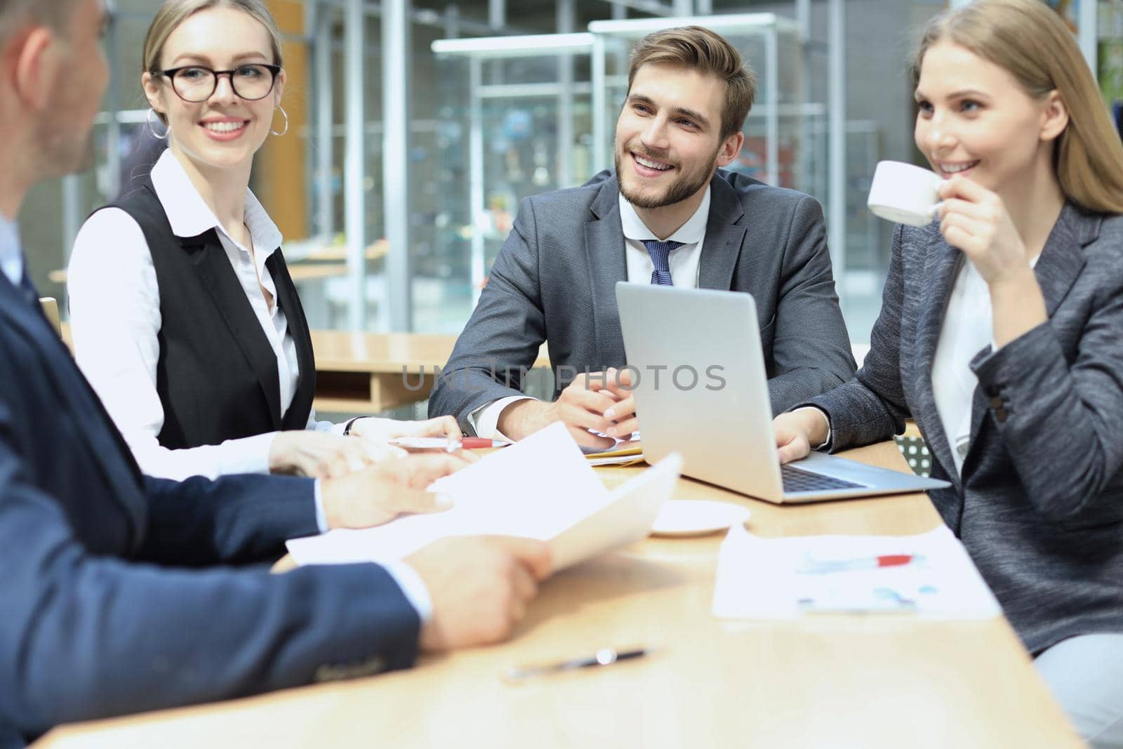 Group of business partners discussing ideas and planning work in office