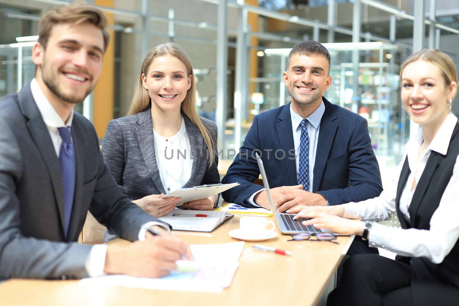 Businessman with colleagues in the background in office