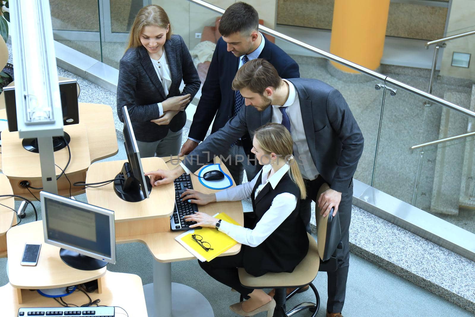 Top view of buiness team brainstorming while sitting at the office table together