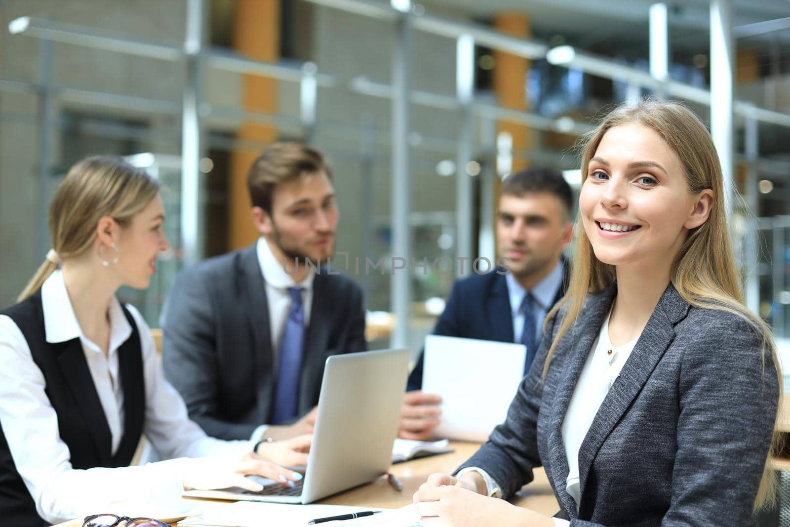 business woman with her staff, people group in background at modern bright office indoors