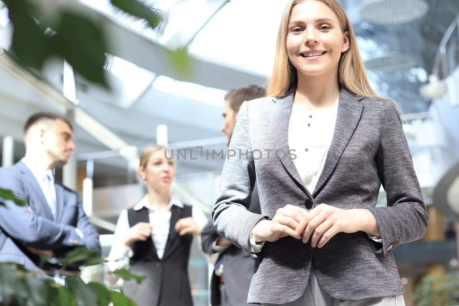 Face of beautiful woman on the background of business people