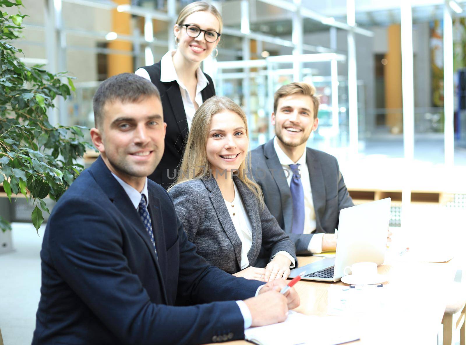 Businessman with colleagues in the background in office