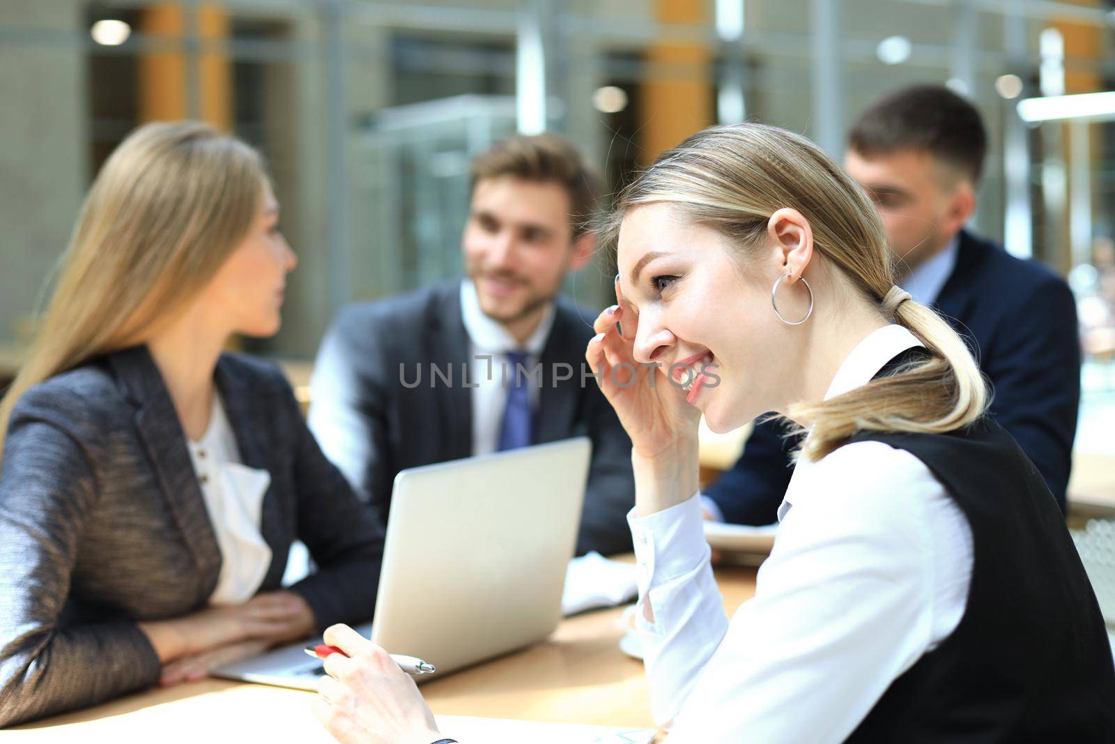 Face of beautiful woman on the background of business people