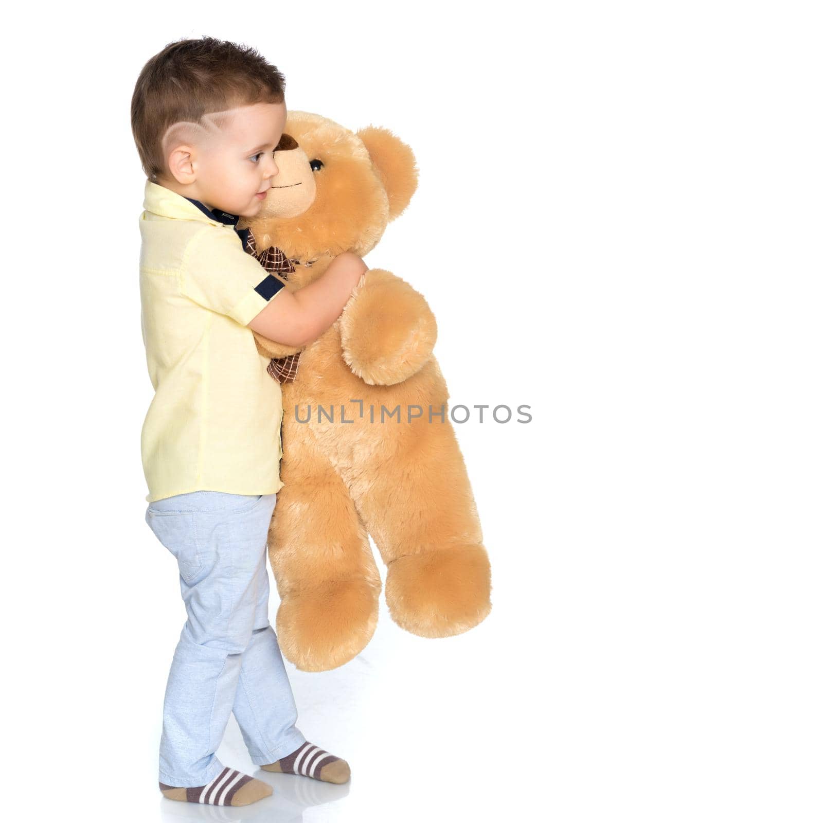 A little boy is playing with a teddy bear. The concept of a happy childhood, games, the development of a child in the family.