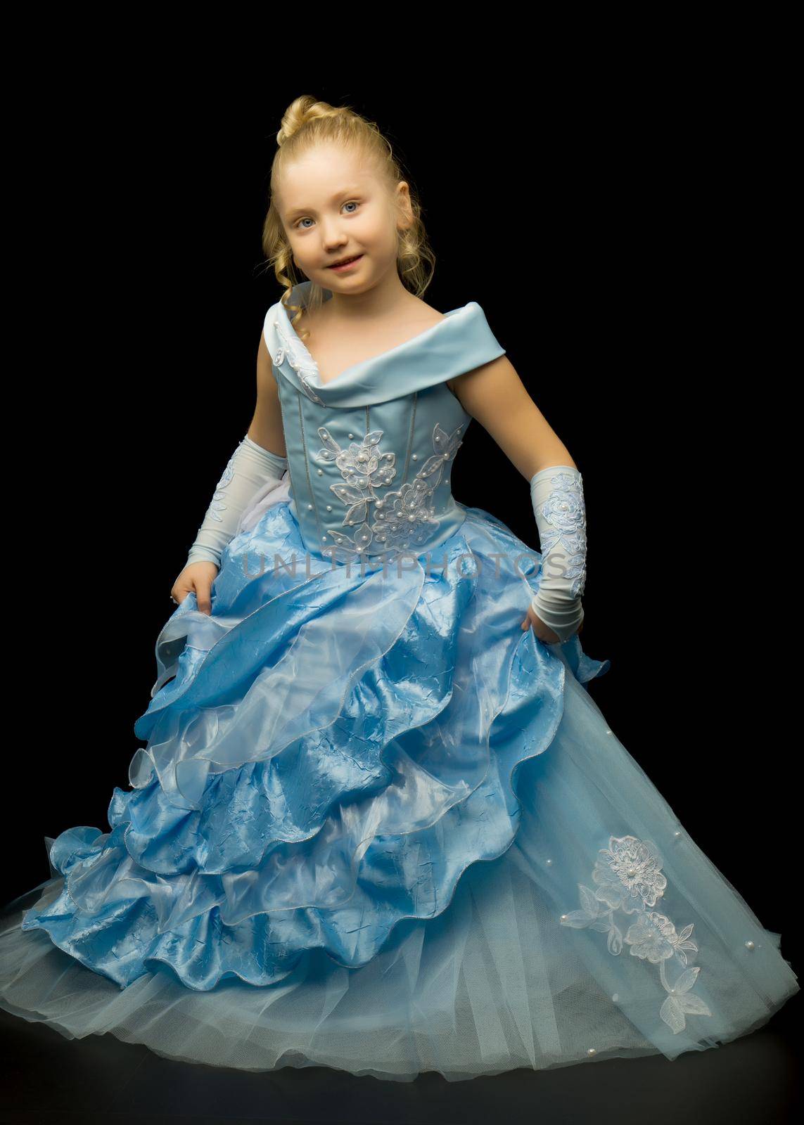 A little girl in a long, elegant dress of a princess on a black by kolesnikov_studio