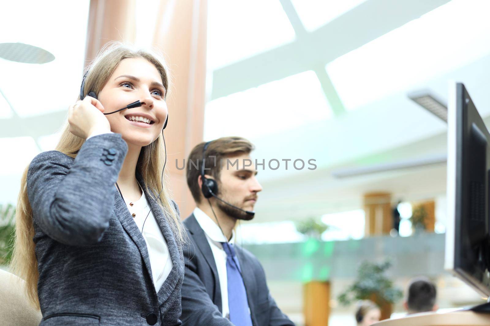 Female customer support operator with headset and smiling