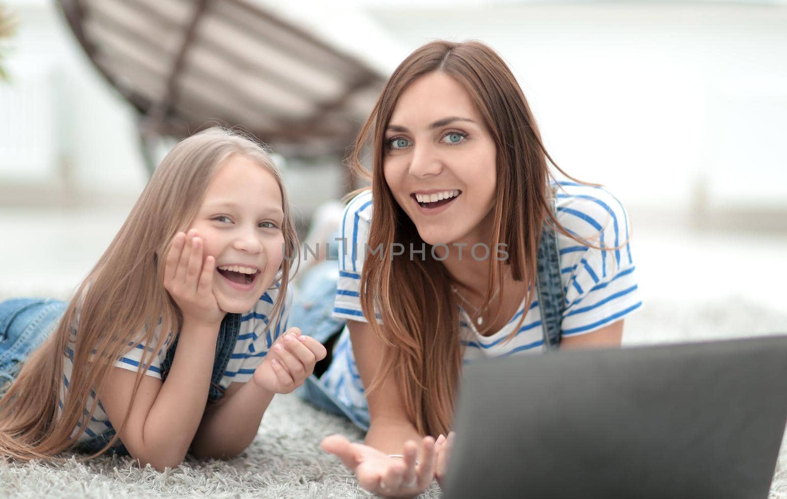 smiling mother and daughter spend their free time together.people and technology