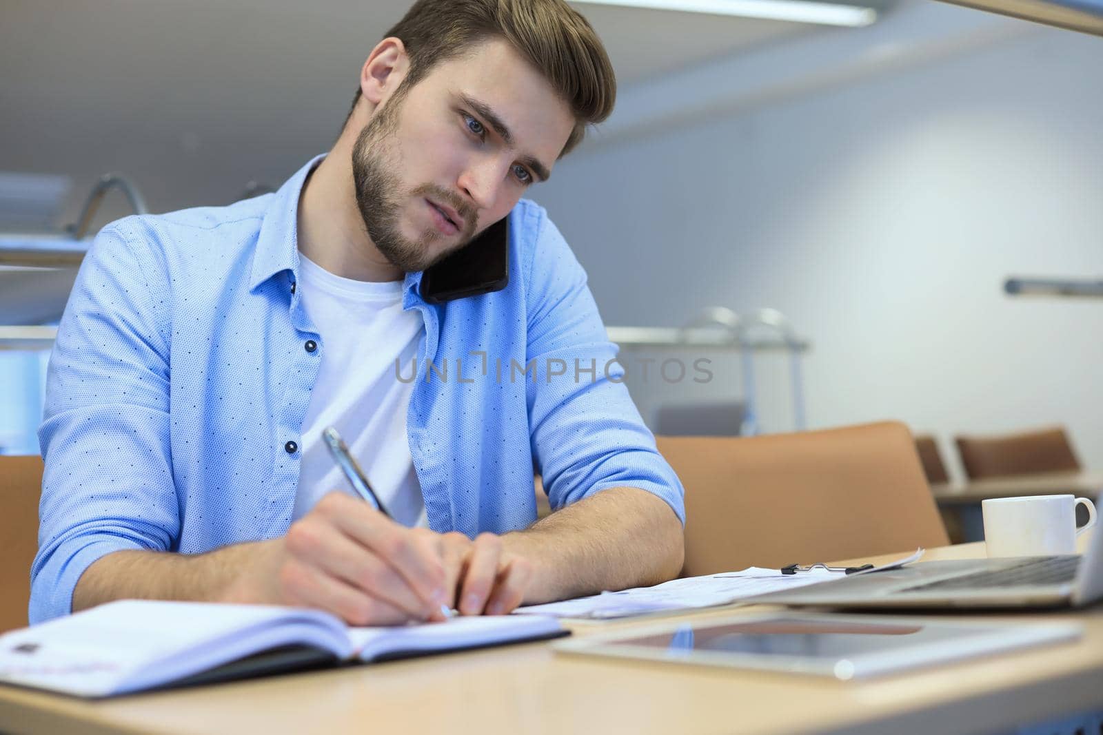 Businessman using his mobile phone in the office
