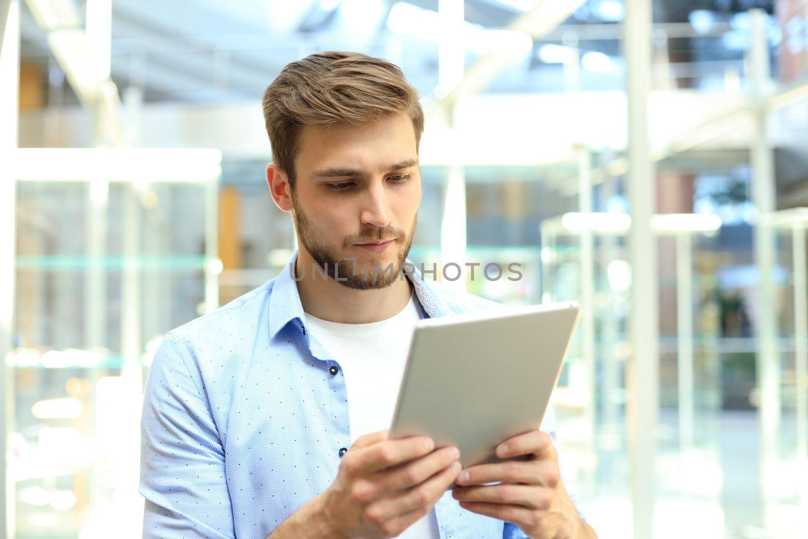 Businessman using his tablet in the office
