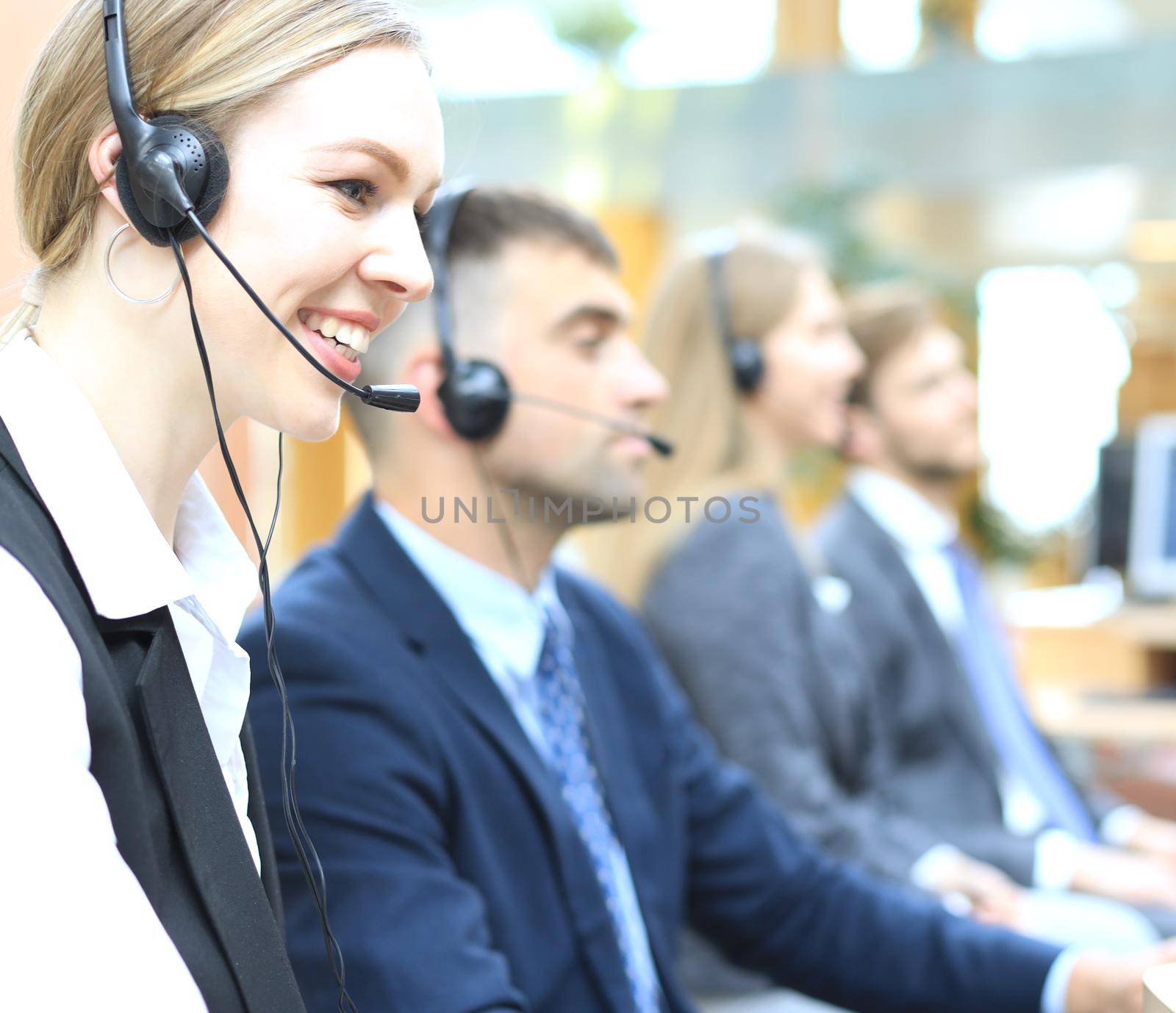 Female customer support operator with headset and smiling. by tsyhun