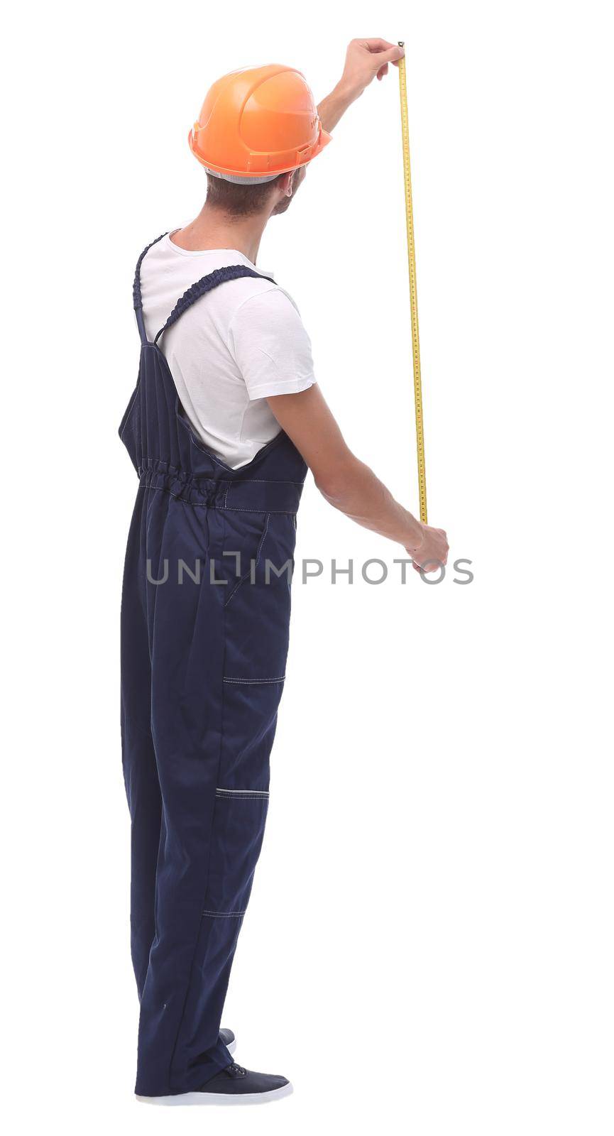 in full growth. young Builder with yellow tape measure. isolated on white background