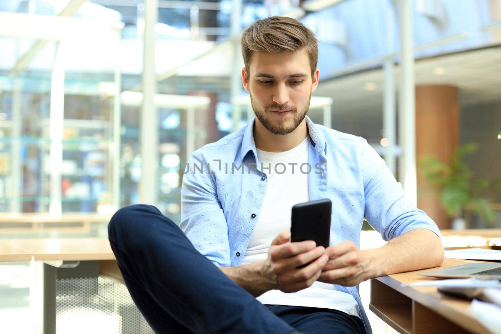 Businessman using his mobile phone in the office