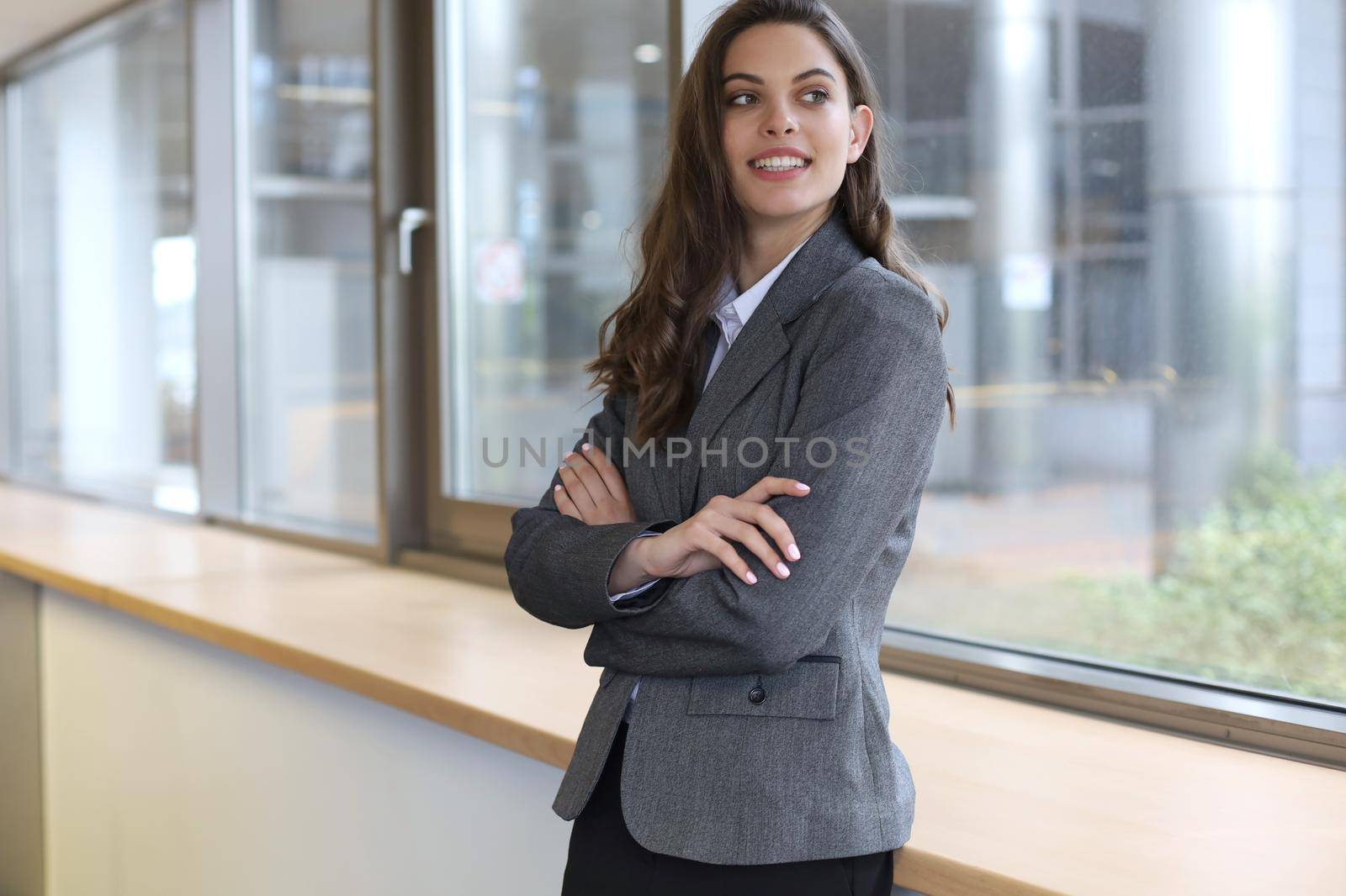 Attractive businesswoman standing near desk in the office