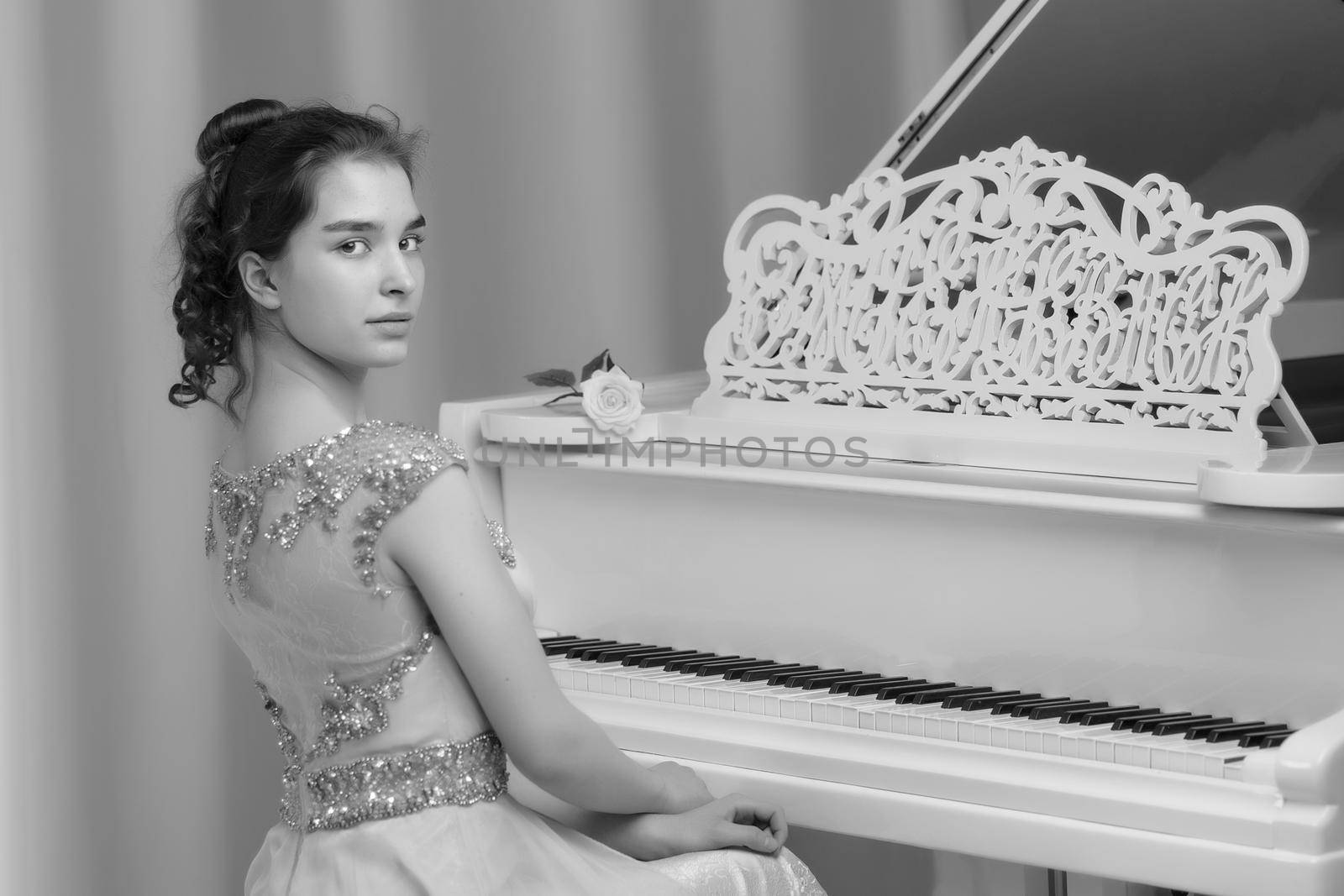 A teenage girl is playing on a white grand piano. by kolesnikov_studio