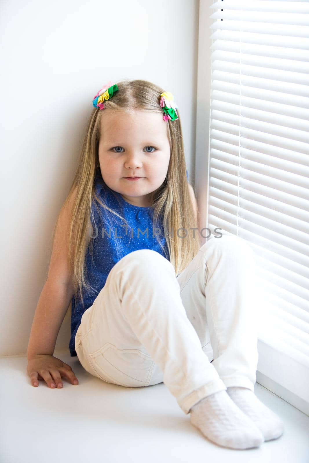 Girl sitting on the windowsill by kolesnikov_studio