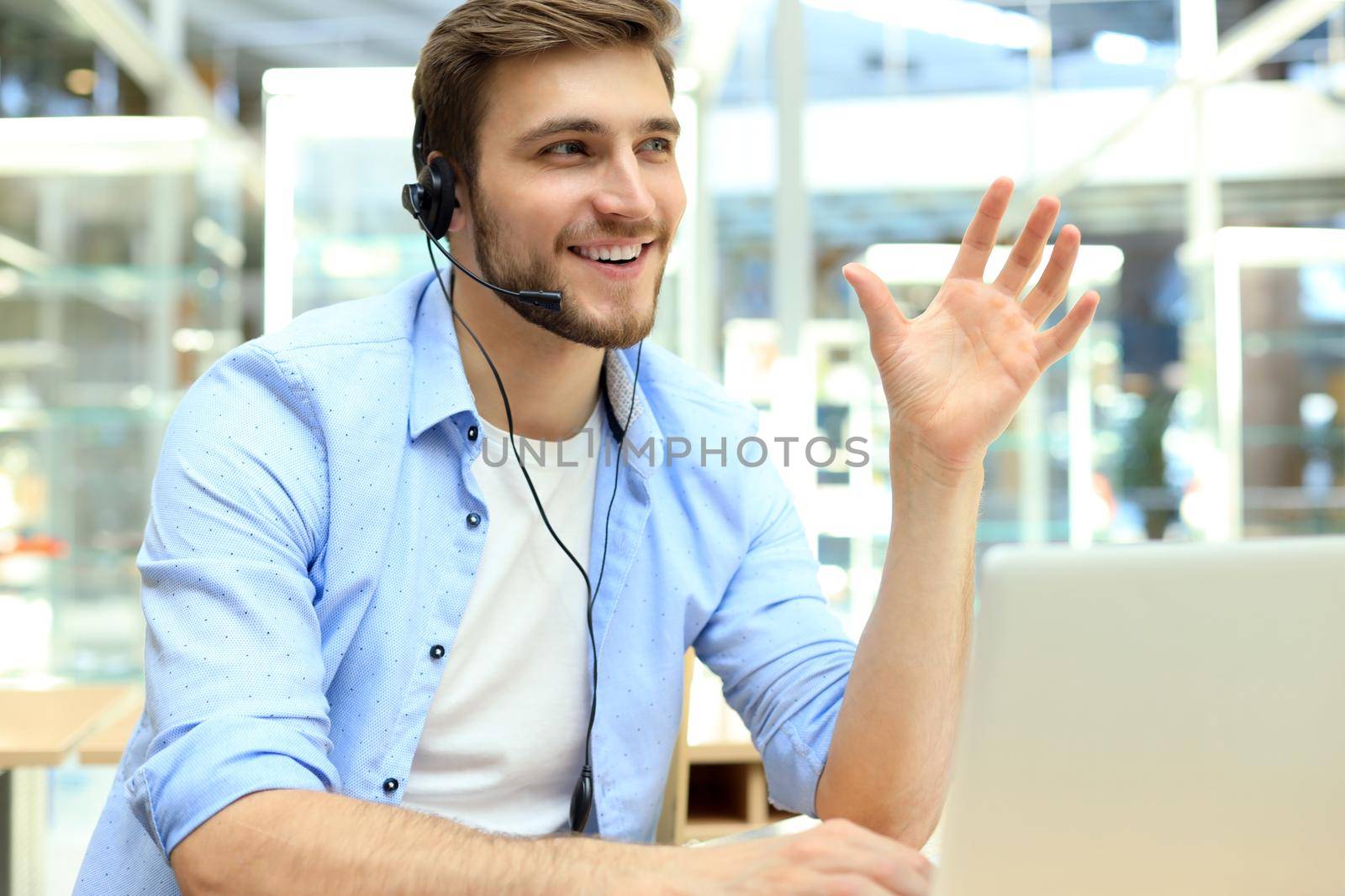 Smiling friendly handsome young male call centre operator. by tsyhun