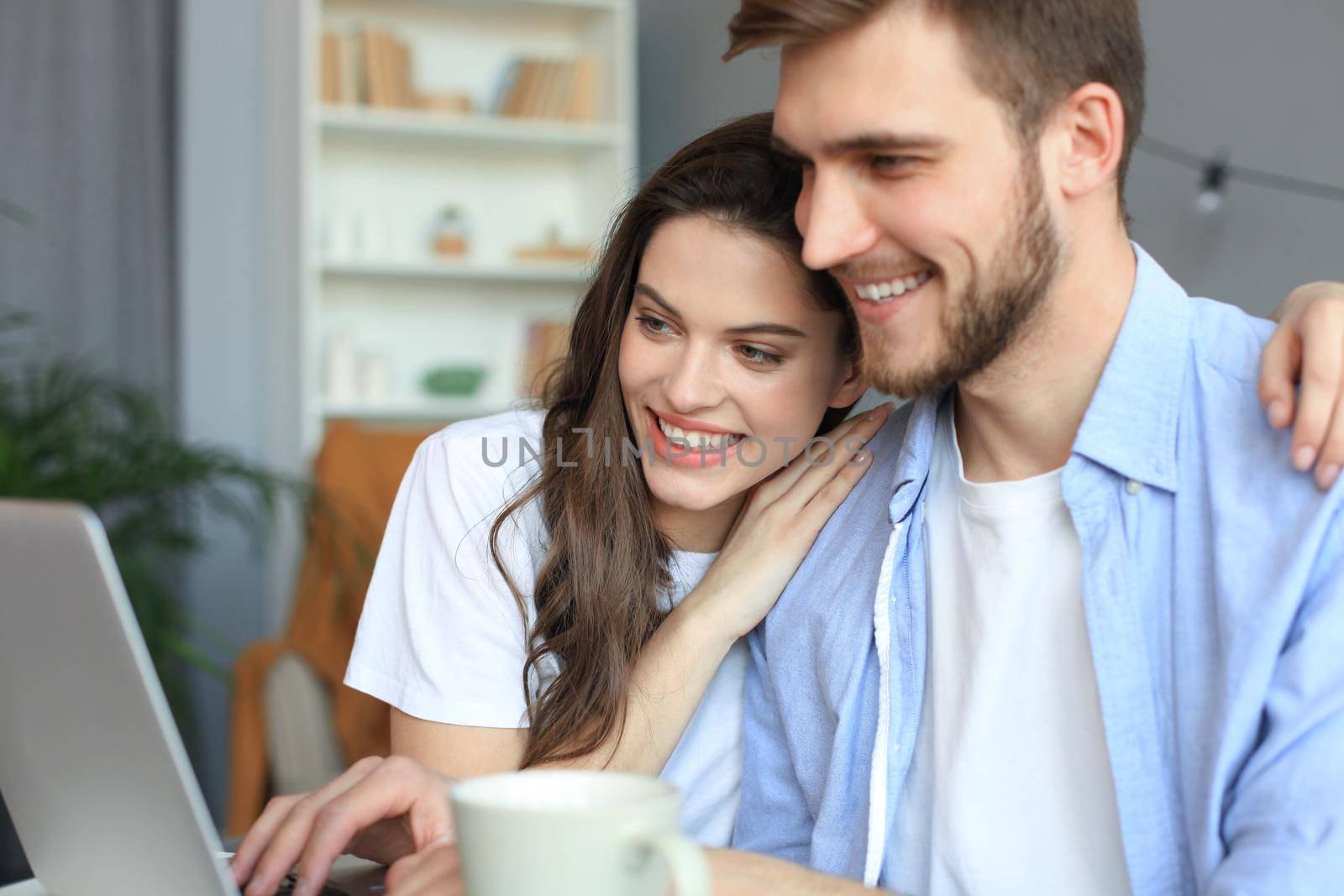 Couple pointing while working together on laptop